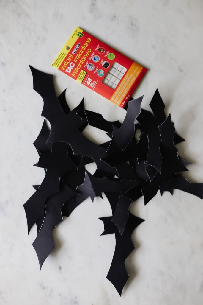 Halloween handmade decor. How to make funny paper bat. Cutting the shape  with scissors. Step 2. Top view, flat lay Stock Photo